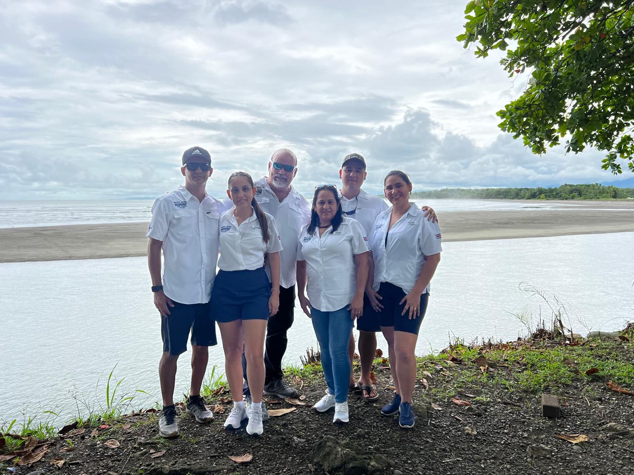 White Shore Marine team standing on the beach in Herradura